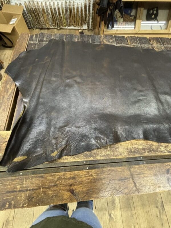 Dark brown leather hide on wood.