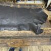 Large piece of brown leather on a table.