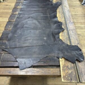 IMG_2825 Dark brown leather hide on wood table.