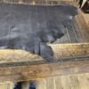 Black leather on wooden surface.