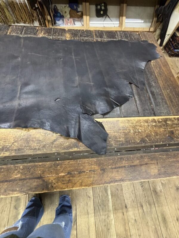 Black leather on wooden surface.