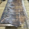 Brown leather hide on wood table.