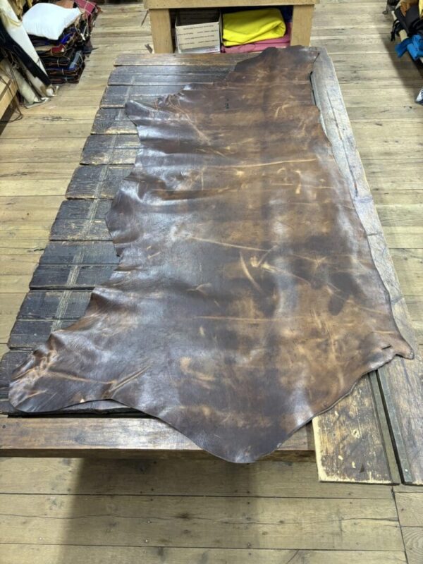 Brown leather hide on wood table.