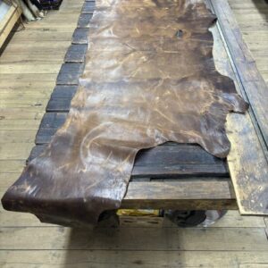 IMG_2839 Large brown leather hide on wood table.