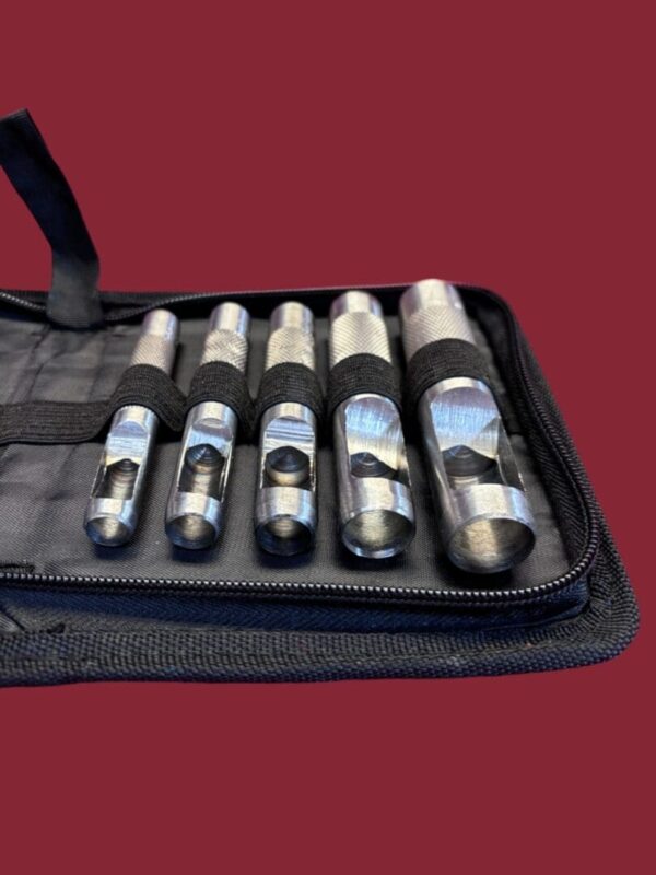 Set of metal hole punches in case.