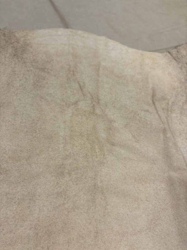 Close-up of beige suede texture.