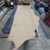 Large tan leather hide on table.