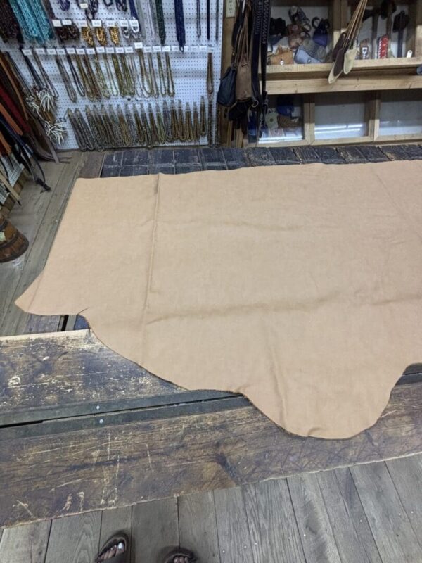 Tan leather hide on wooden floor.