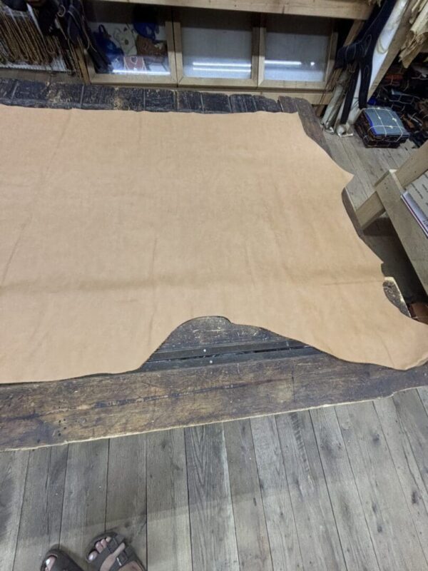 Tan leather on a wooden floor.