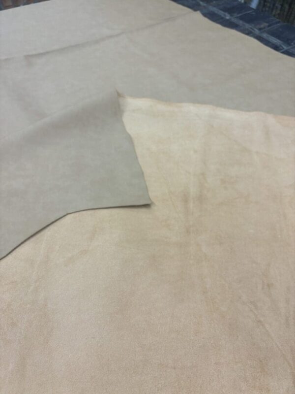 Two pieces of beige suede fabric.