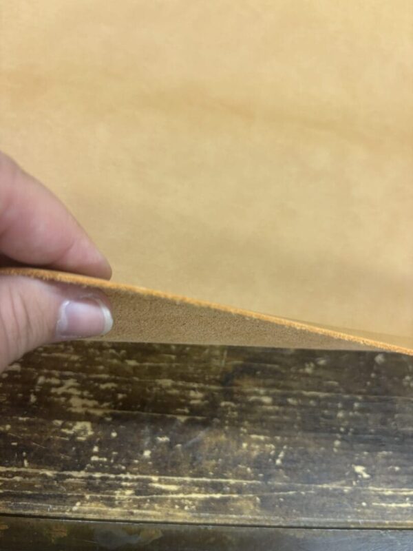 Tan leather revealing wood grain.