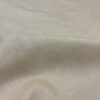 Cream colored fabric with texture.