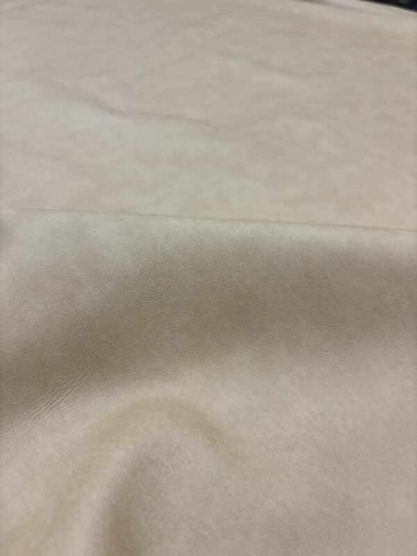 Cream colored fabric with texture.