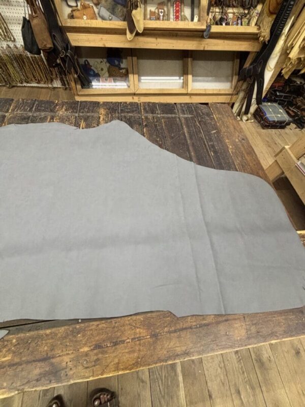 IMG_3069 Light gray leather hide on wood table.