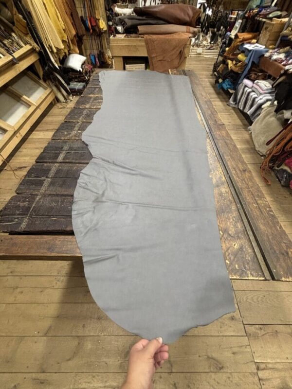 Gray leather hide on wooden table.