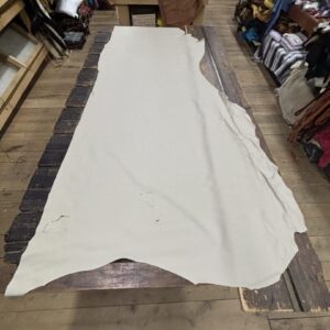IMG_3081 White leather hide on a wooden table.