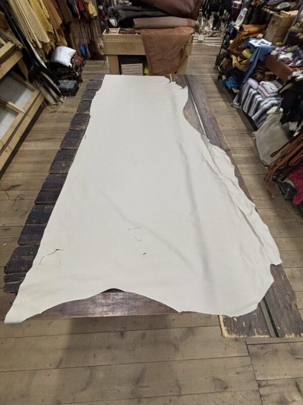White leather hide on a wooden table.