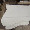 White leather hide on wooden floor.