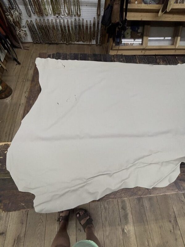 White leather hide on wooden floor.