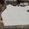 White leather hide on wooden surface.
