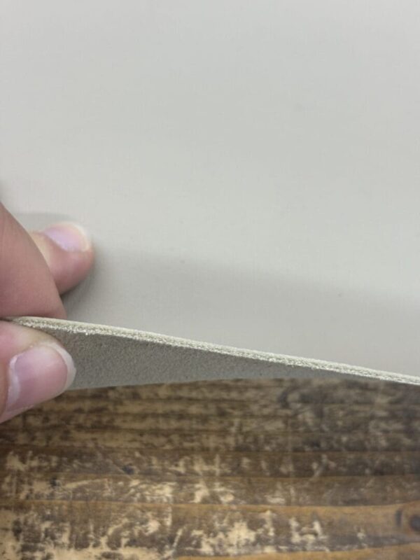 Close-up of light grey leather.