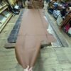 Brown leather hide on wooden table.