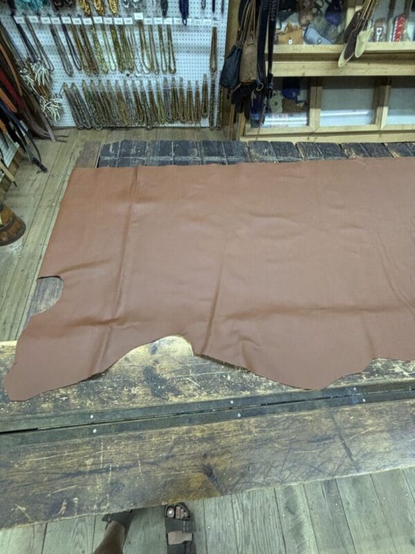 Brown leather sheet on wooden table.