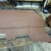 Brown leather hide on wooden floor.