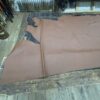 Brown leather hide on wooden table.