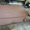 Large brown leather sheet on wood floor.