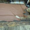 Brown leather hide on wooden floor.