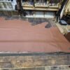 Brown leather on wooden workbench.
