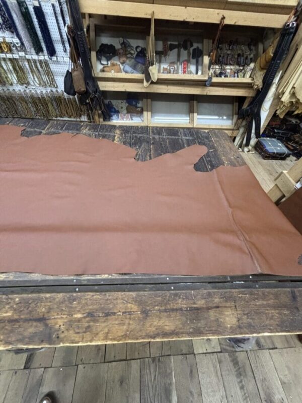 Brown leather on wooden workbench.