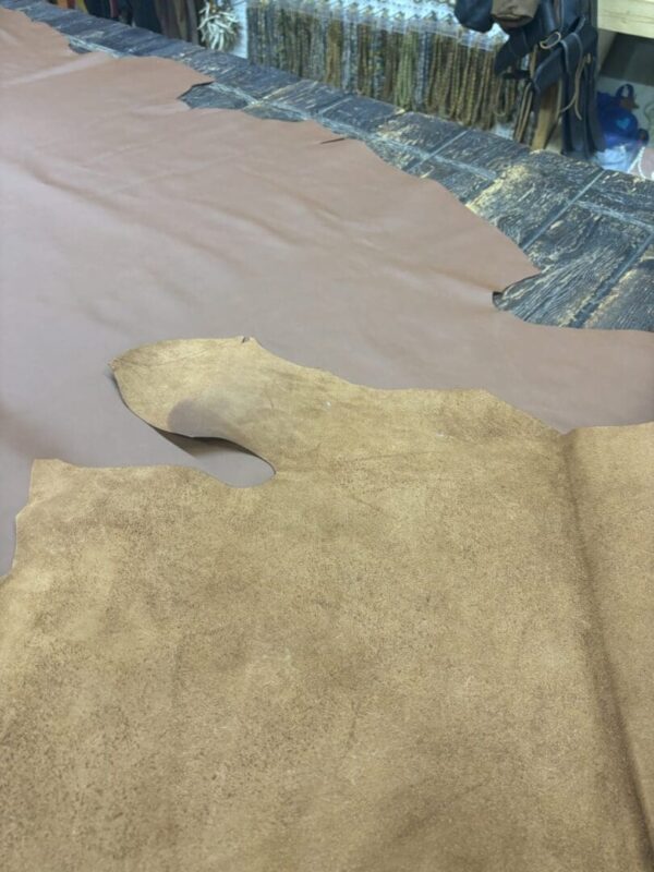 Tan leather hide on a wooden table.