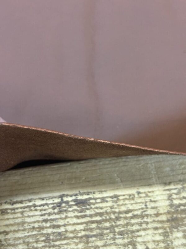 Brown leather on a wood surface.