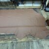 Brown leather hide on wooden table.