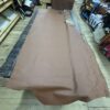 Large brown leather hide on wooden floor.