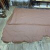Brown leather hide on wooden floor.