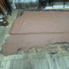 Brown leather hide on wooden floor.