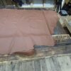 Brown leather hide on wooden surface.