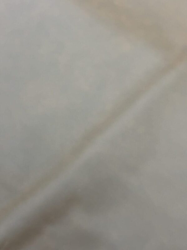 Off-white fabric texture background.