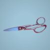 Silver shears with red handles.