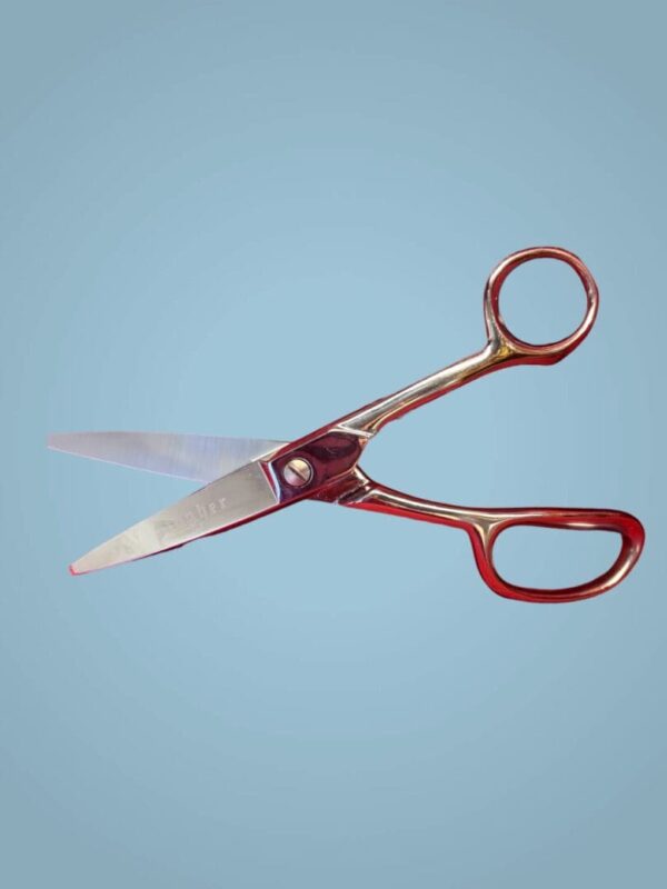 Silver scissors with red handles.