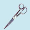 Silver Gingher scissors on blue background.