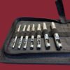 Set of metal hole punch tools in a case.