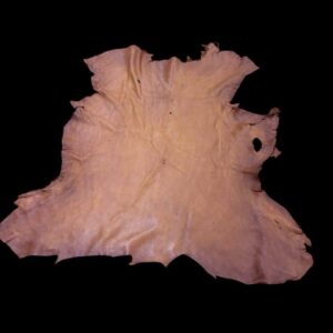BZNA8678 Tanned leather hide against a black background.
