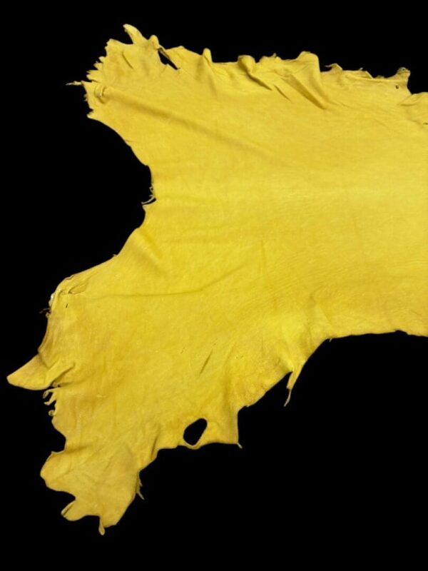 Yellow textured fabric on a black background.