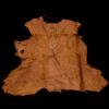 Ancient leather garment on black background.