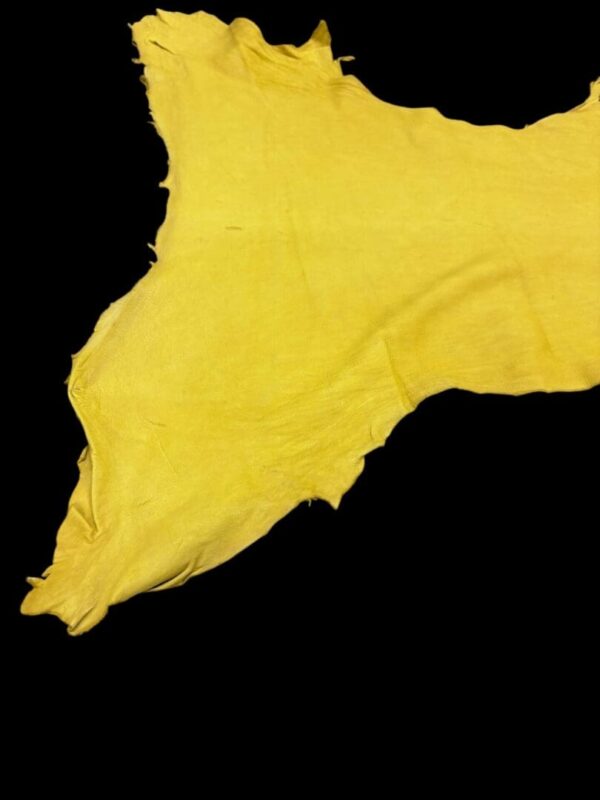 Bright yellow fabric piece on black background.