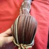 Braided leather strips on a red surface.